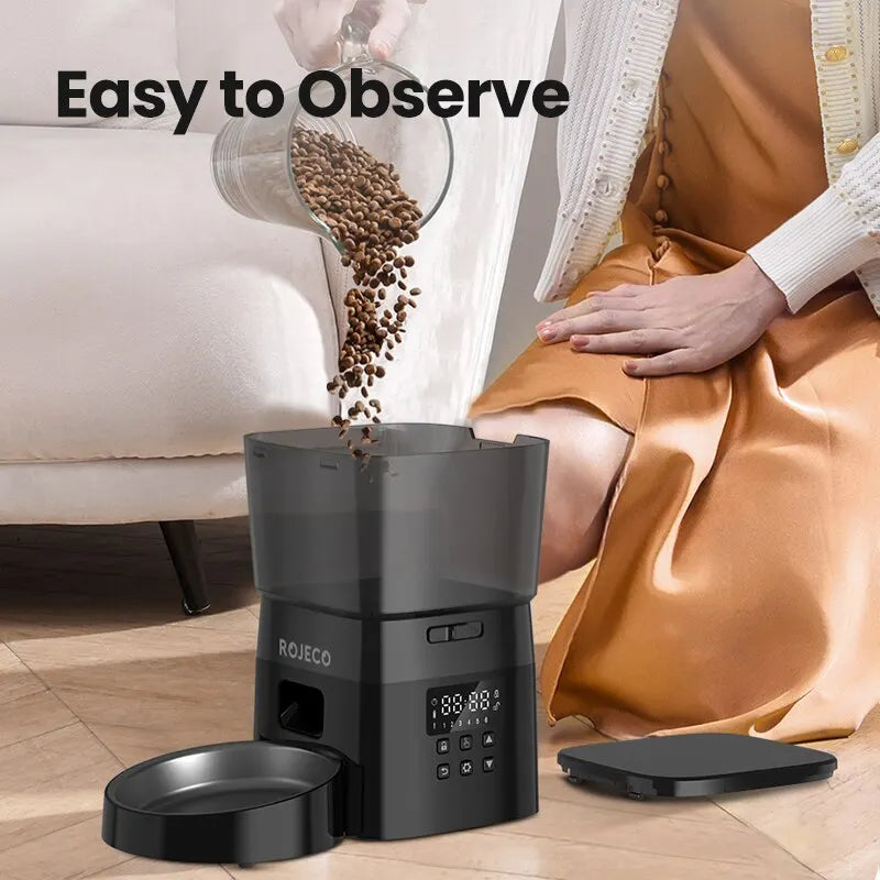 Snugll timed dog feeder with portion control pouring dry dog food into black automatic pet feeder