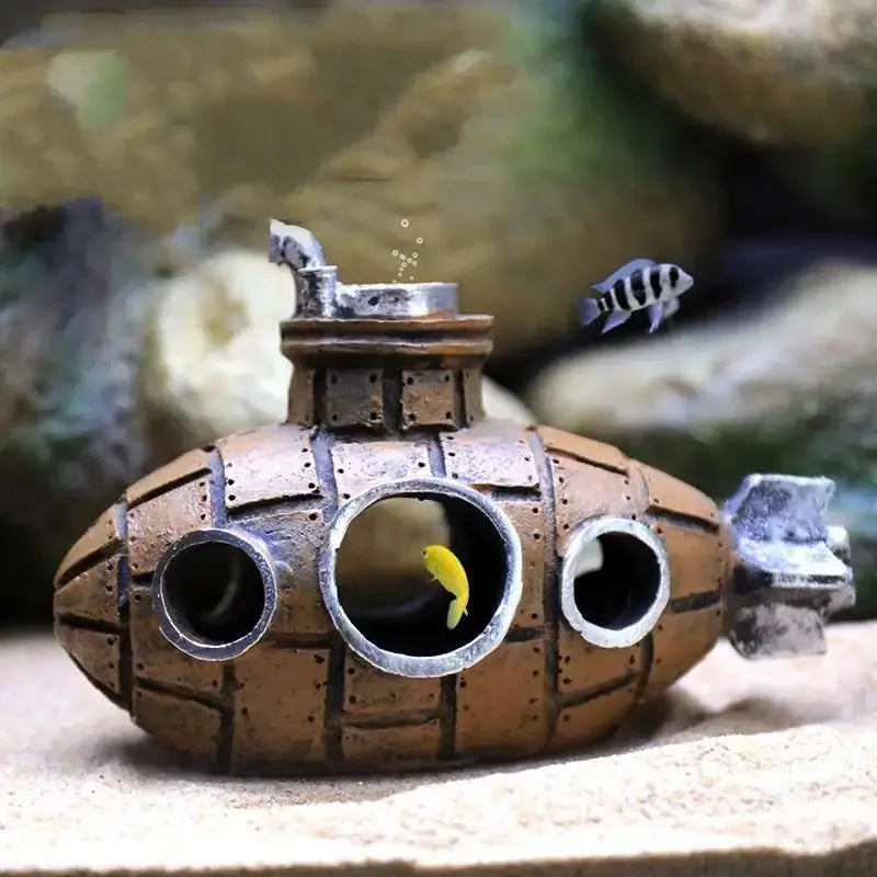 Snugll aquascaping submarine accessory in aquarium with small yellow and striped fish inside and around it