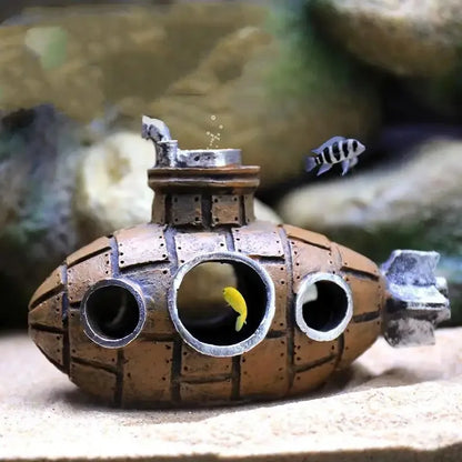 Snugll aquascaping submarine accessory in aquarium with small yellow and striped fish inside and around it