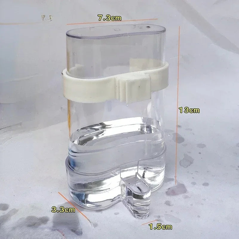 Snugll clear plastic automatic bird feeder with white clip and water reservoir measuring 13 cm tall
