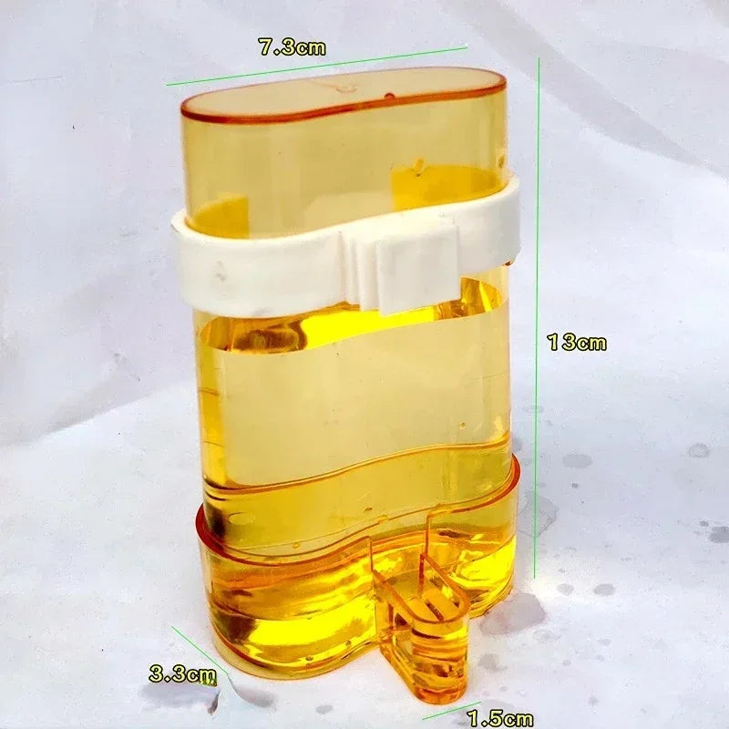 Snugll automatic bird feeder transparent yellow water container with white clip and compact design