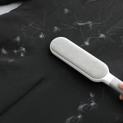 Snugll electrostatic pet hair remover cleaning white pet hair from black fabric surface