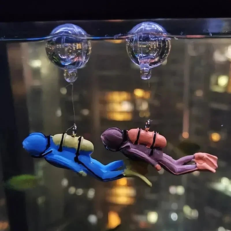 Snugll floating blue diver aquarium decor attached to aquarium glass with suction cup