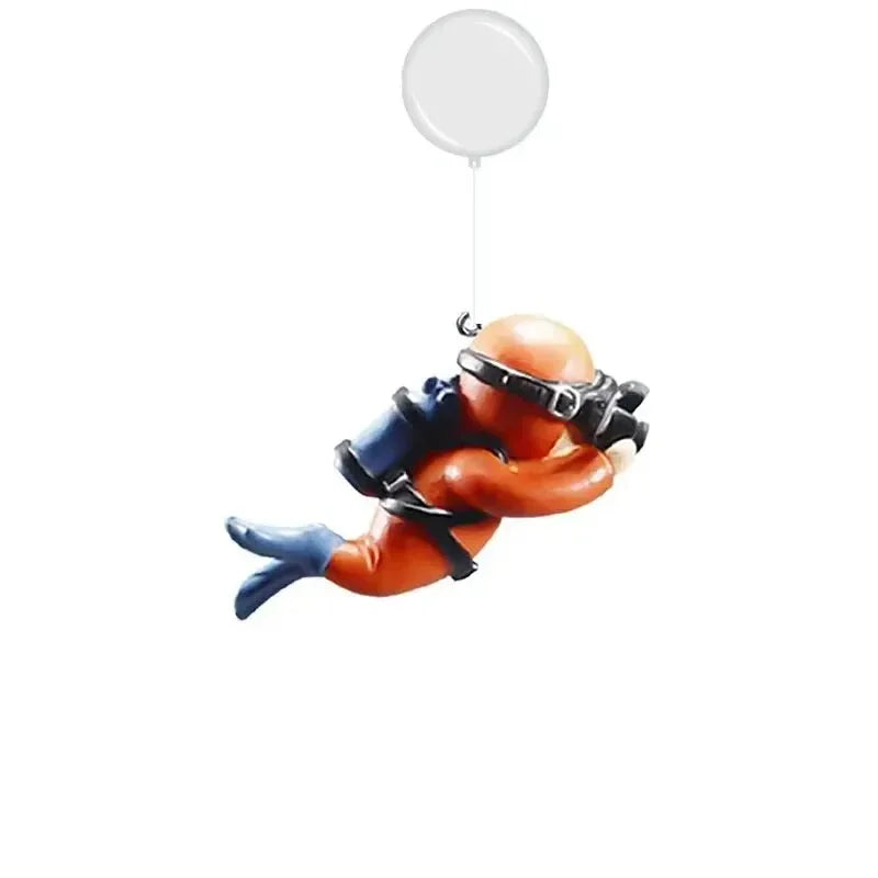 Floating blue diver aquarium decor with orange diver figurine and scuba gear hanging from a clear balloon