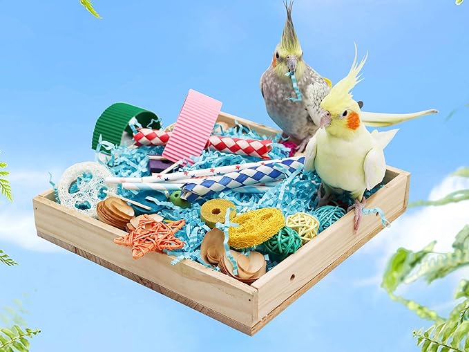 Parrot chew toys box with colorful wooden and rope toys for birds in a wooden tray