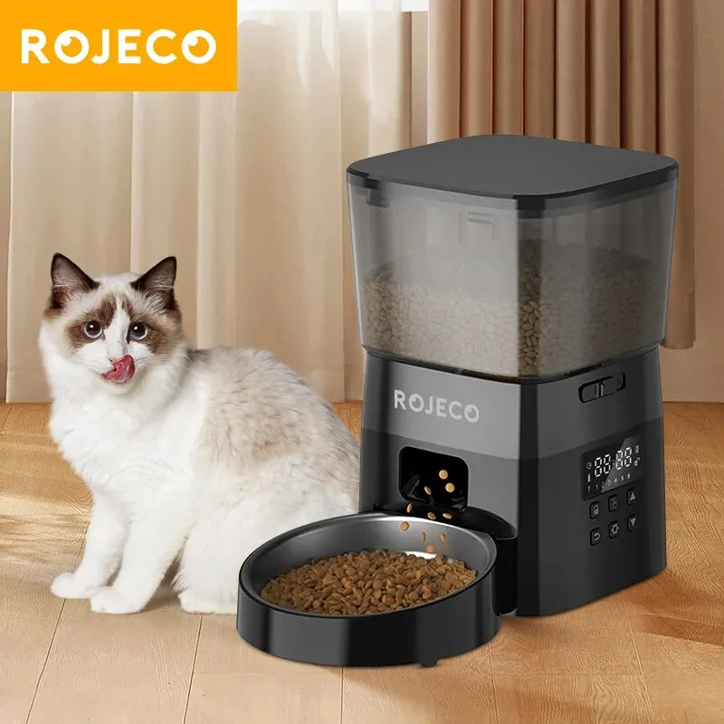 ROJECO timed dog feeder with portion control dispensing dry dog food bowl with cat nearby
